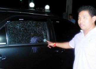 One of the victims points to the damage to his SUV.